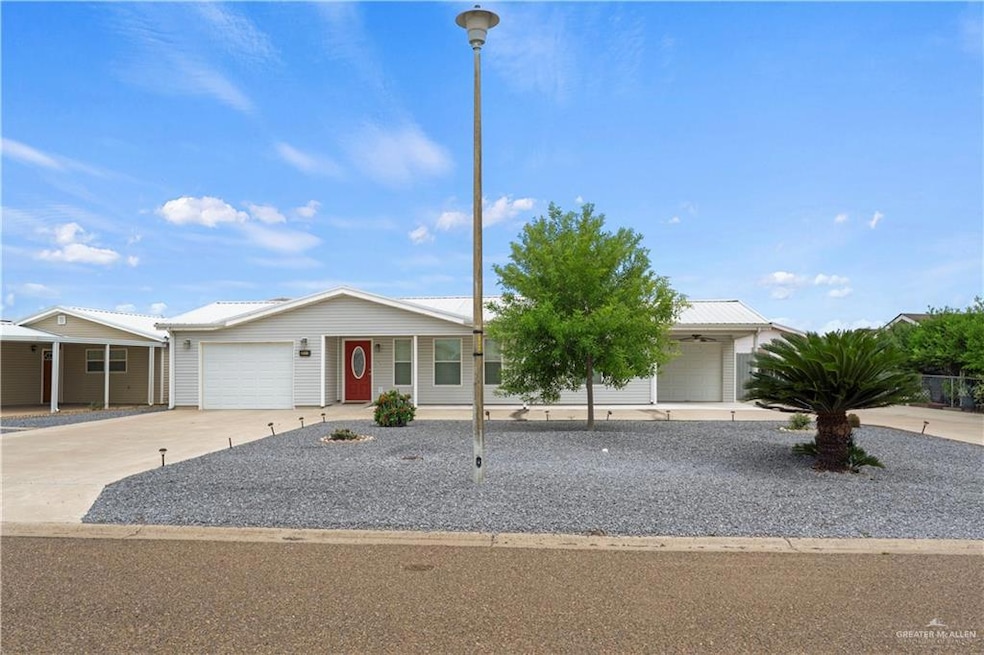 Single story home with driveway, a garage, and a porch