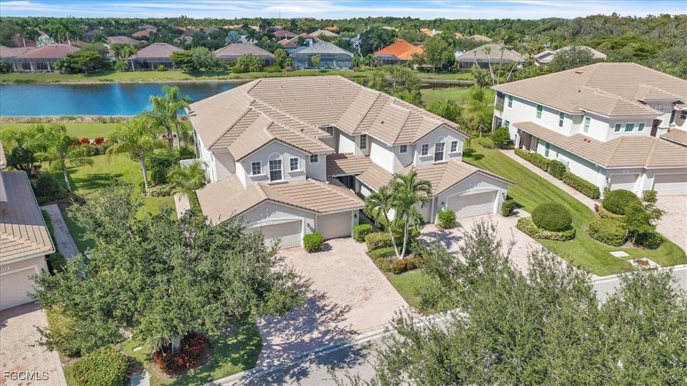 Aerial view of residential area featuring a large body of water