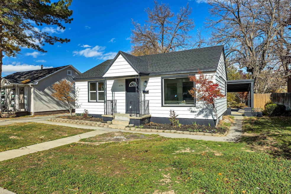 View of front of home featuring a shingled roof