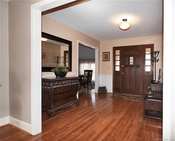 Very spacious foyer area with a beautiful wood entry door.