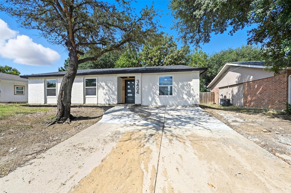 View of front of home featuring driveway and brick siding