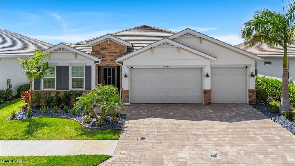 Ranch-style house with decorative driveway, an att