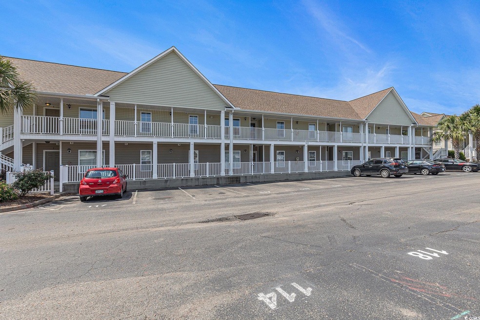View of property featuring uncovered parking