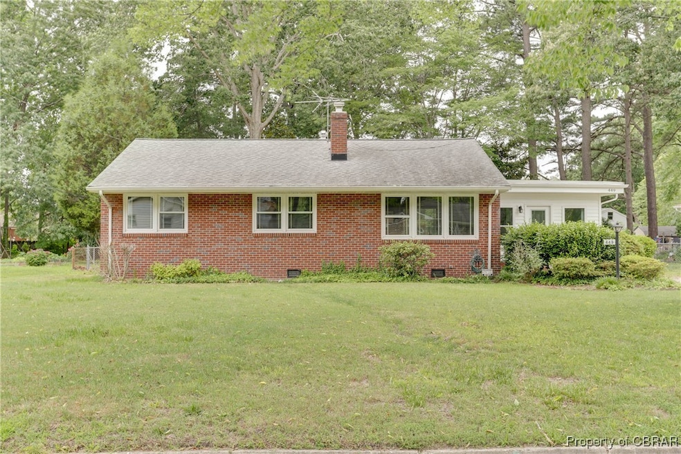 View of front of home with brick siding, a front y