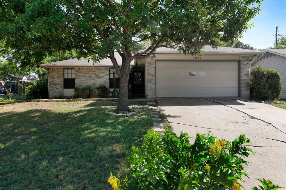 View of front of property featuring a garage, con