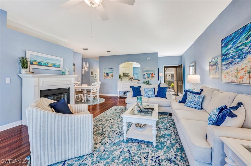 Living room with ceiling fan and wood-type floorin