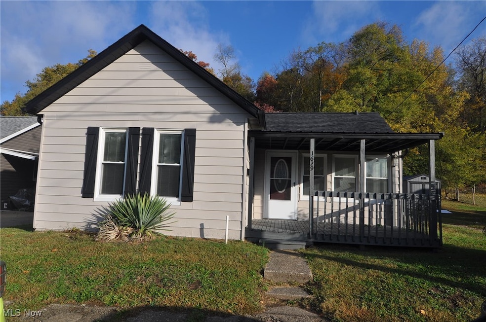 Bungalow-style house with a front yard, a covered porch, and roof with new shingles