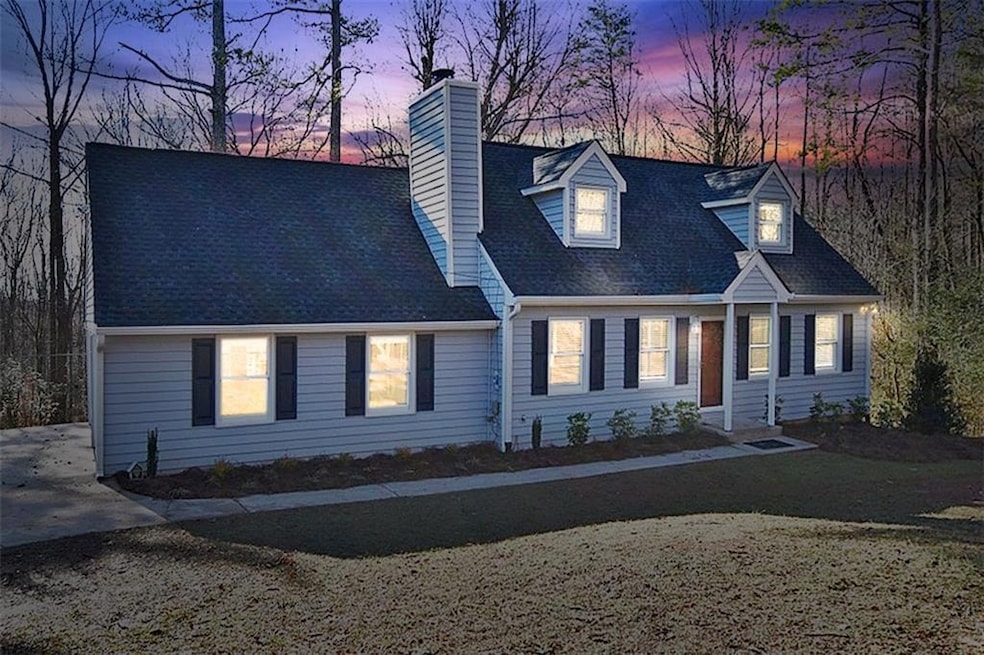 New england style home featuring a chimney