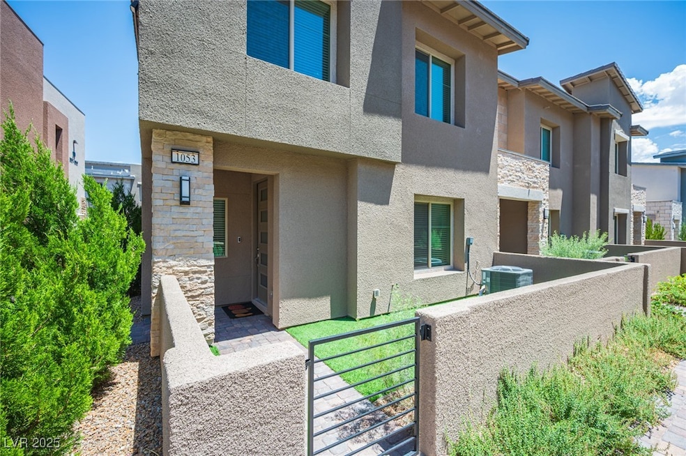 View of front of house with stucco siding and ston