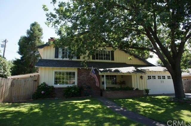 Mature landscape and large shade tree shelter this
