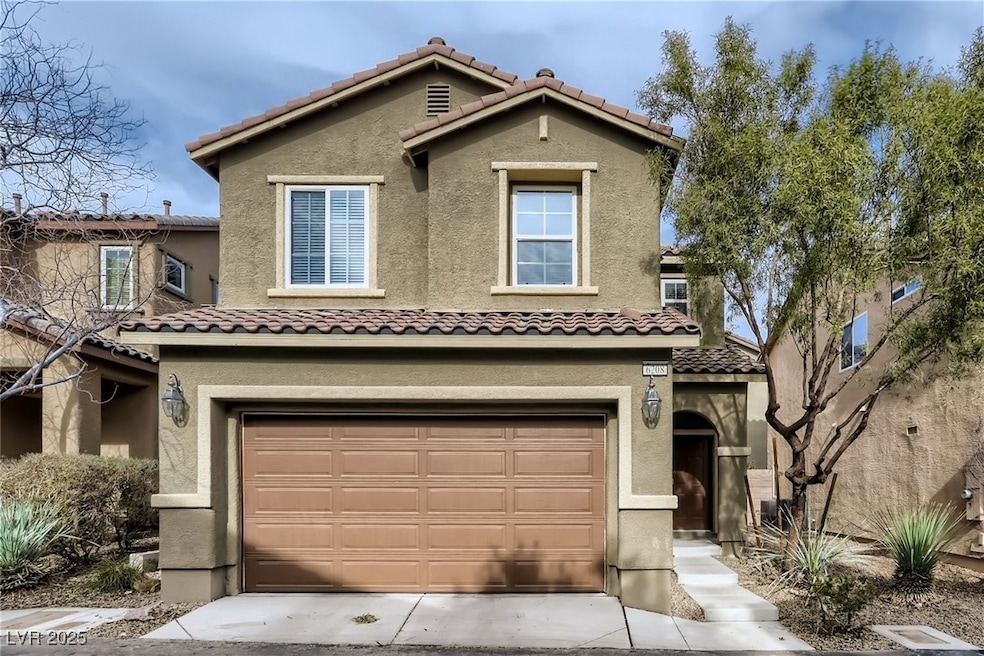 View of front of home with a garage, stucco siding