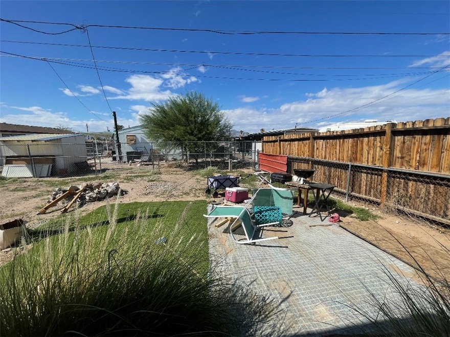 Fenced backyard with a patio area