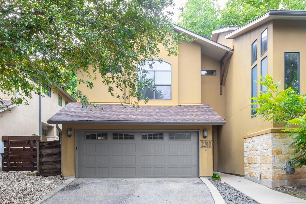 View of front of home with stucco siding, concret