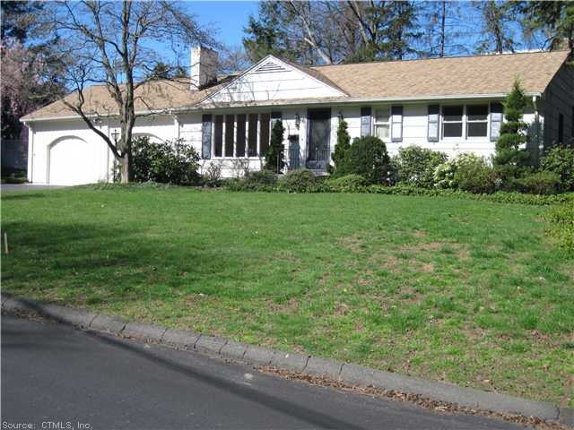 Exterior Front. Flowering trees and shrubbery add 