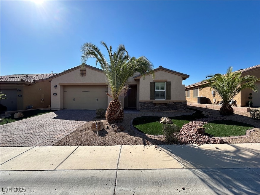 View of front of home with a garage, stucco siding