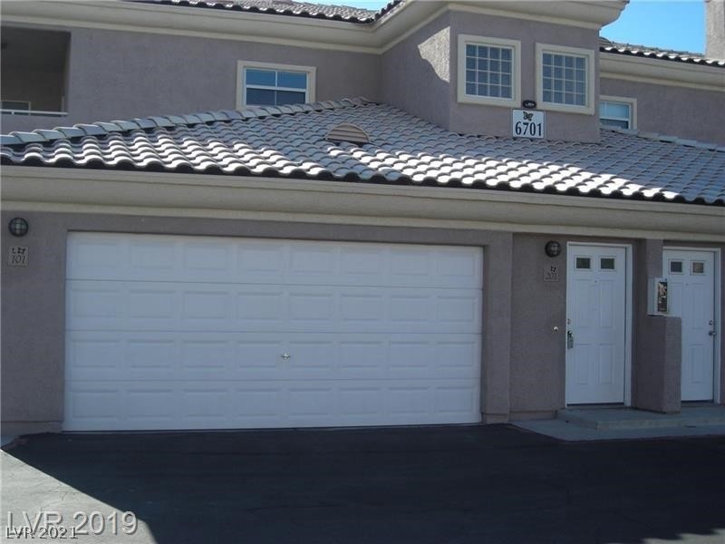 Front of Condo with 2-Car Garage