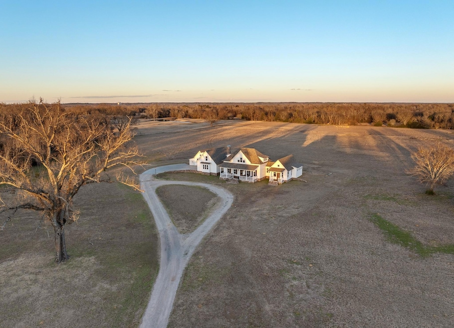 Aerial view at dusk featuring a rural view