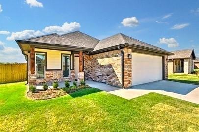 View of front of house with a front lawn and a garage