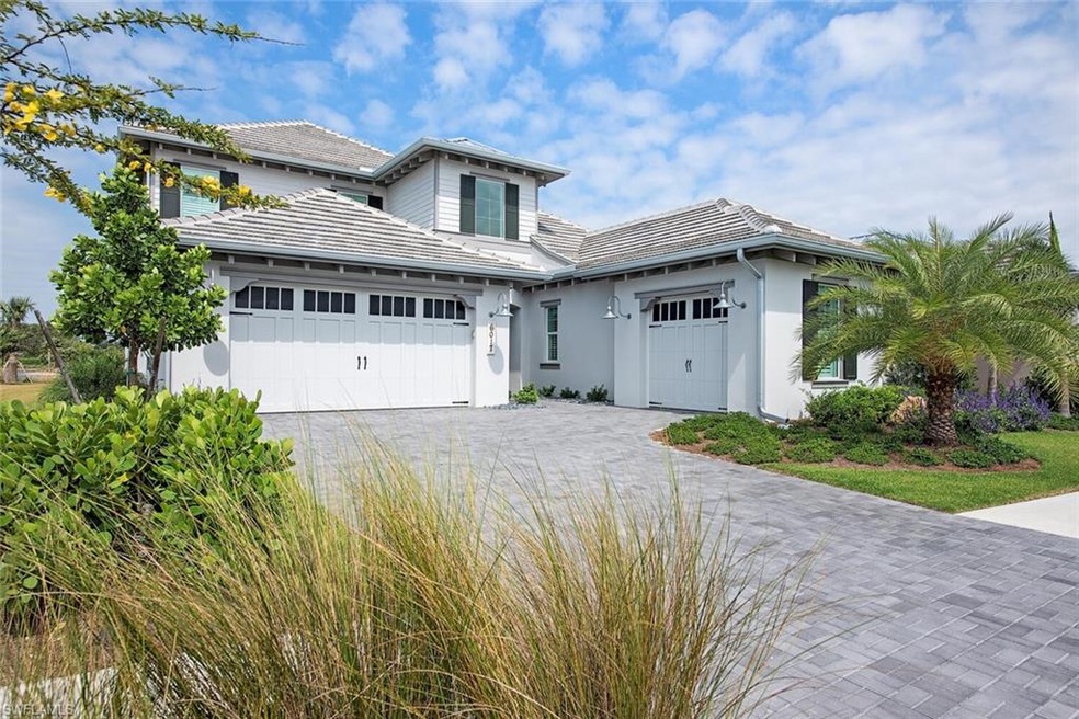Tropical landscaping, a two-car and one-car garage