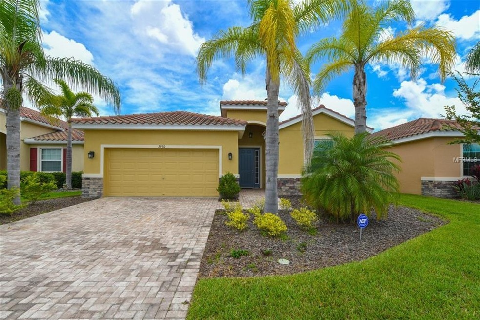 Note driveway brick pavers and tiled roof.