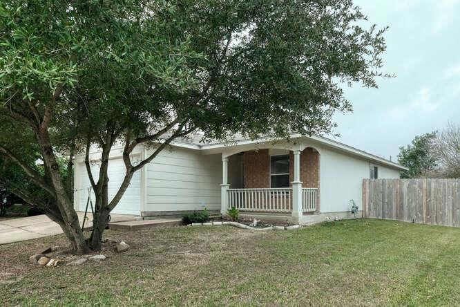 Ranch-style house with covered porch and concrete
