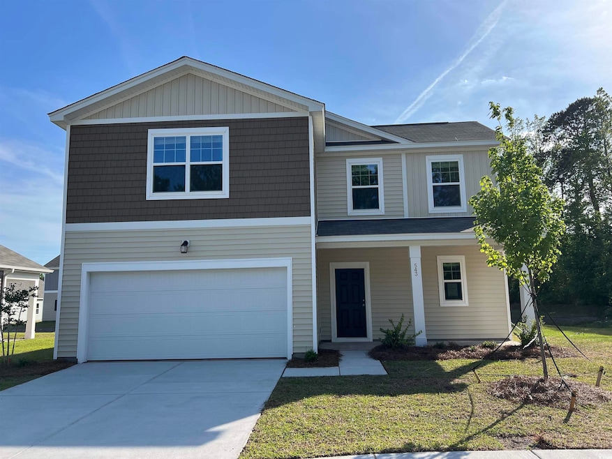 View of front of home featuring driveway, a front 
