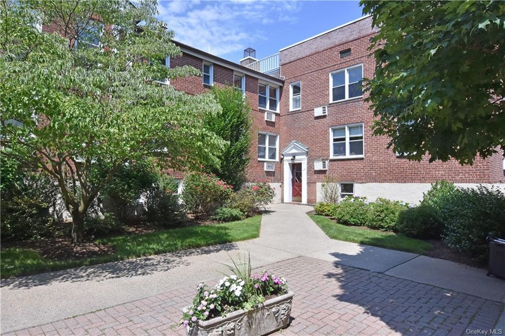 Tree lined walkway to apartment entrance door