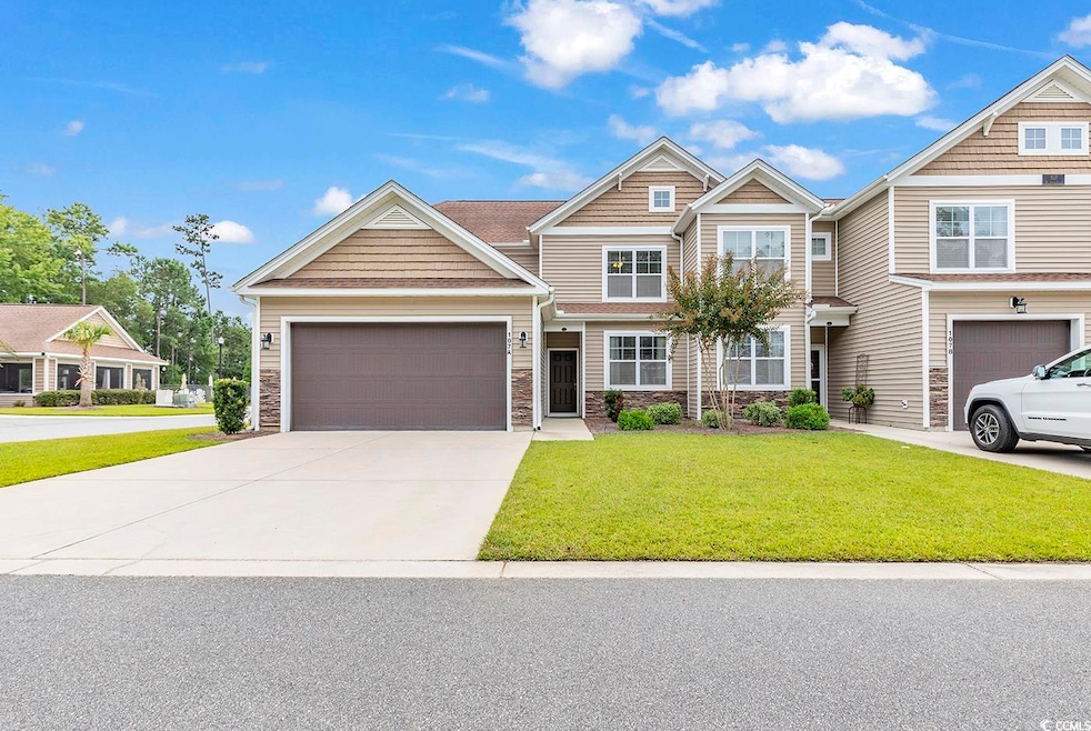 View of front of property featuring a garage and a