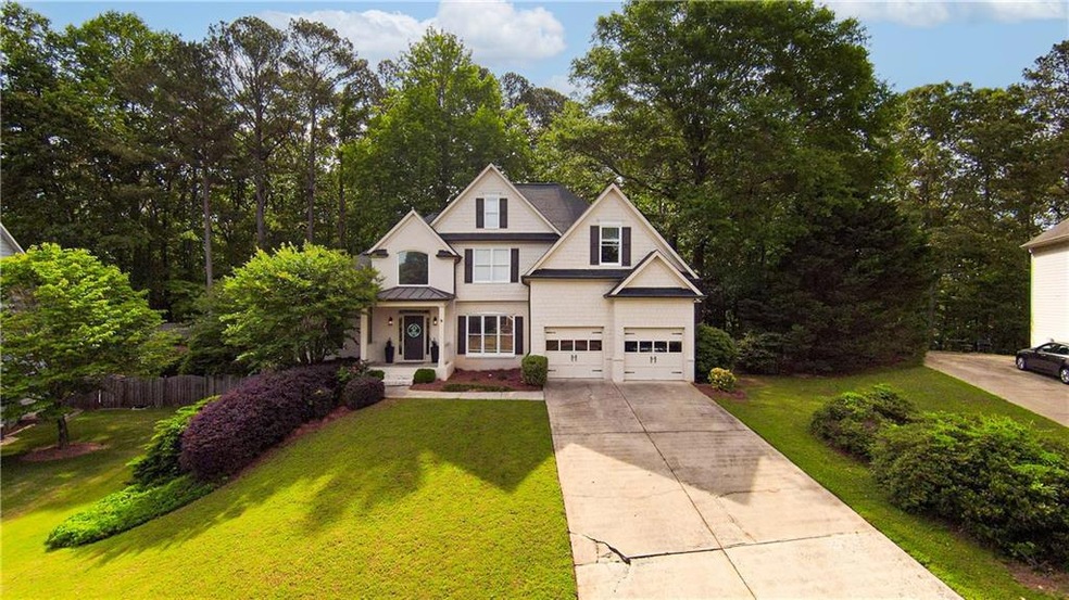View of front of property with driveway, a standin