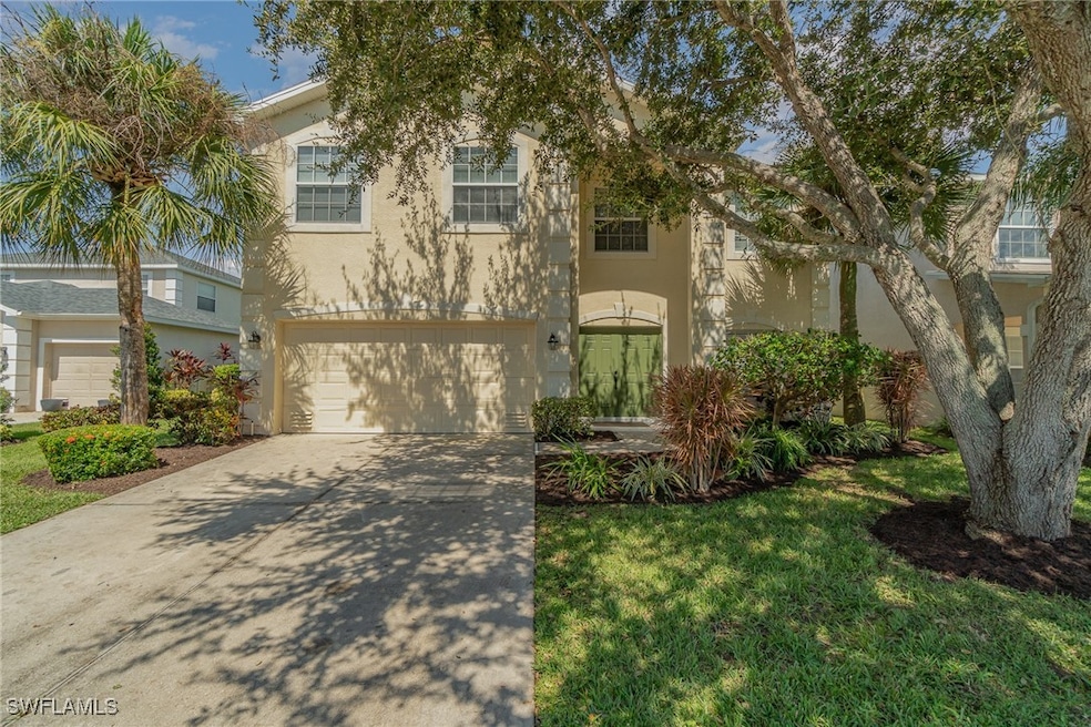 View of front of home with a garage and a front la