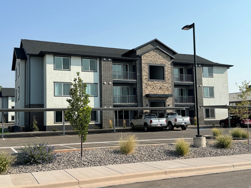 View of building exterior with covered and uncovered parking