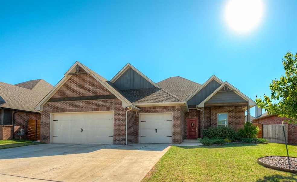 View of front facade featuring driveway, fence, an