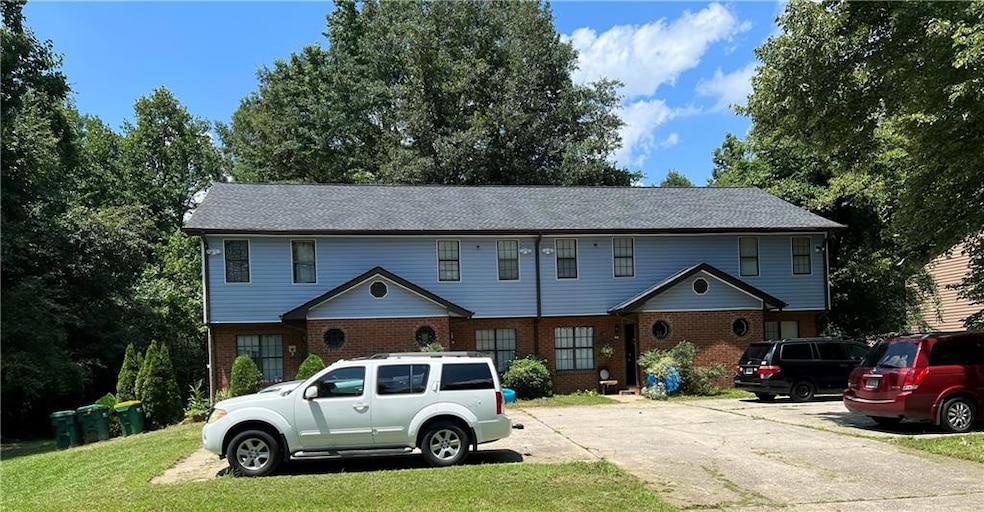 View of front of property with brick siding and a front lawn