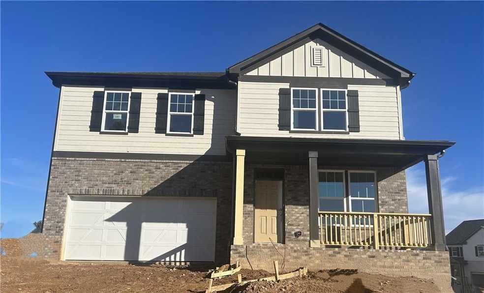 View of front of house with a garage and a porch