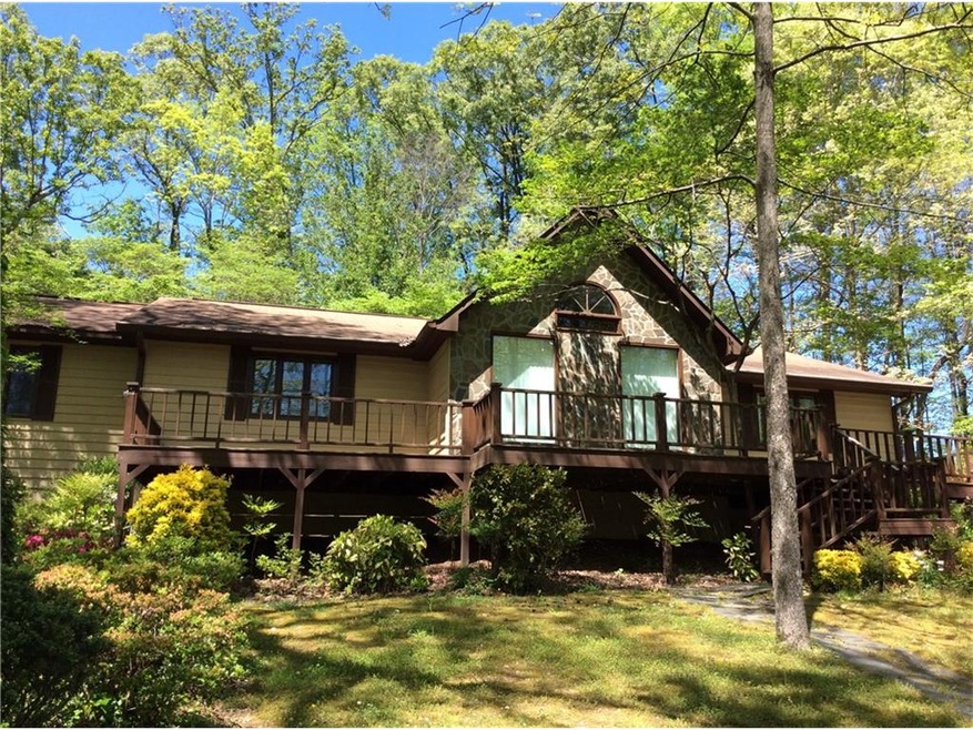 FRONT VIEW OF HOUSE SHOWING LARGE PORCH/DECK AREA