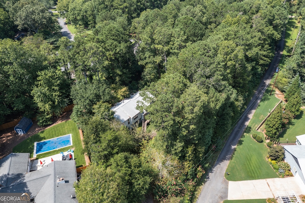 Aerial View - Aerial view of property and surrounding area with a heavily wooded area