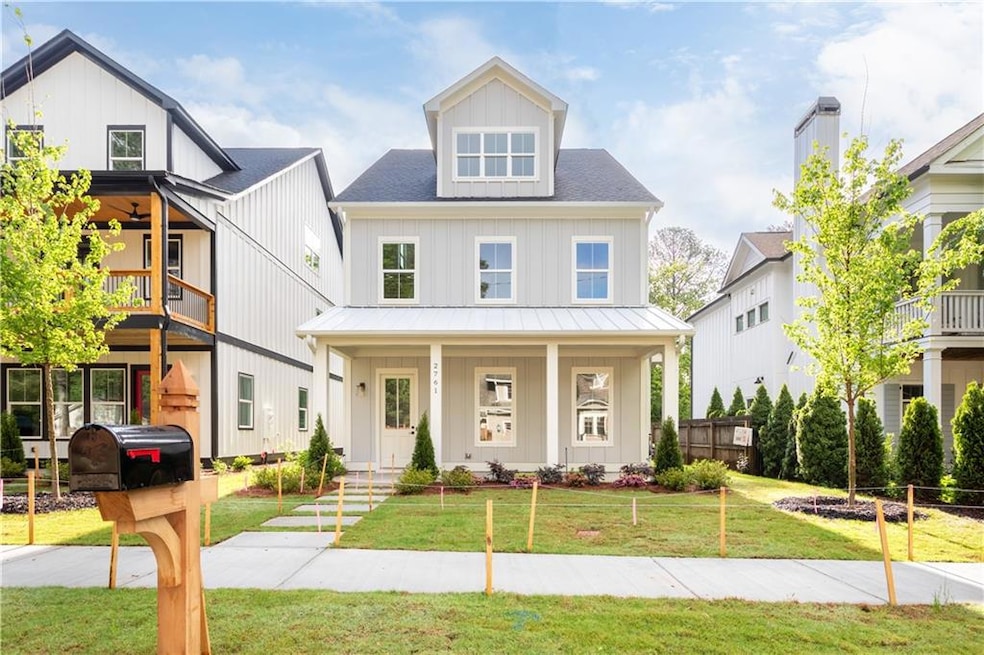 American foursquare style home featuring a front y