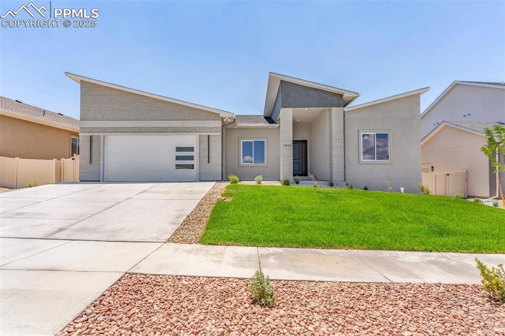 View of front of home with stucco siding, driveway