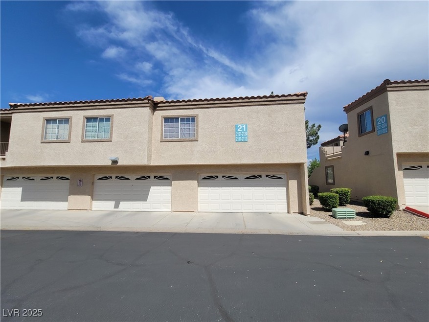 View of front facade with stucco siding, a garage,