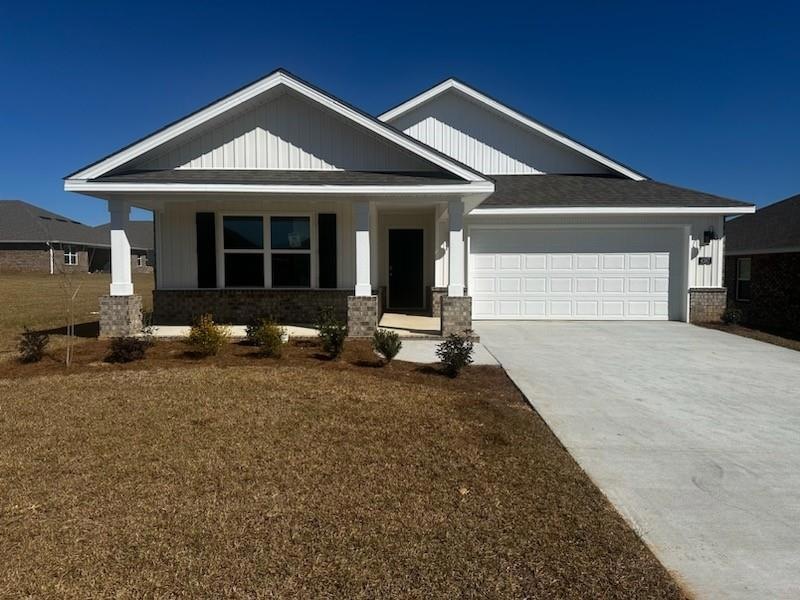 Craftsman-style house with an attached garage, cov