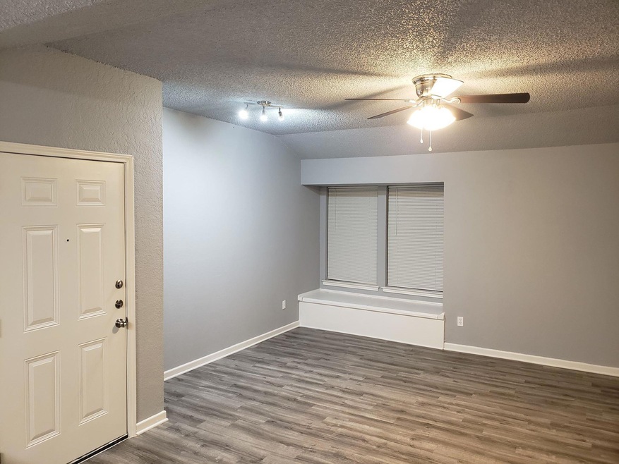 Spare room featuring ceiling fan, wood finished f