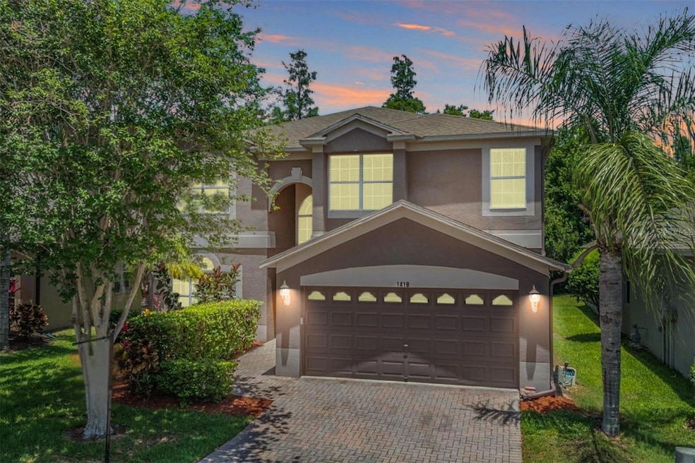 Nestled in hardwoods with a pavered driveway