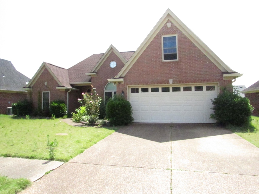 Traditional home with brick siding, concrete driveway, a front lawn, and central air condition unit