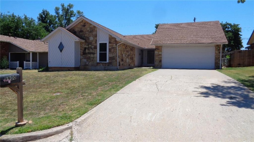 2 car garage with door to side yard. Diamond window is Master Bathroom.
