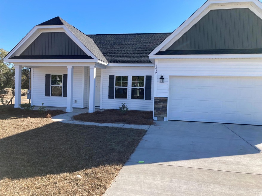View of front facade with a porch and a garage