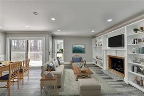 Living room with a fireplace, recessed lighting, and built in shelves