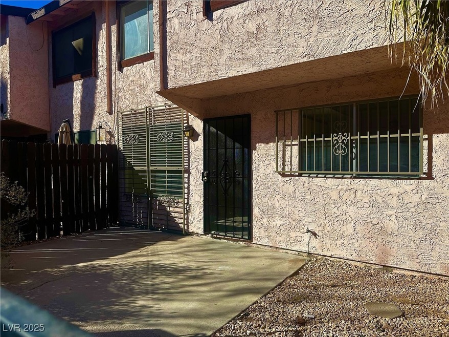 View of exterior entry with fence and stucco sidin