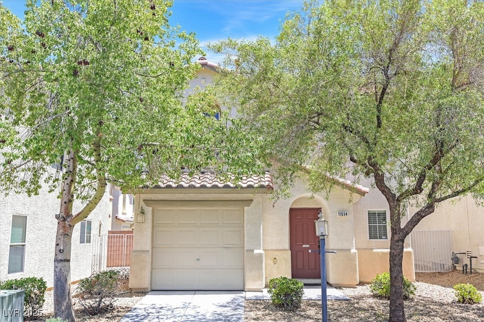 View of front of home with stucco siding, a tiled