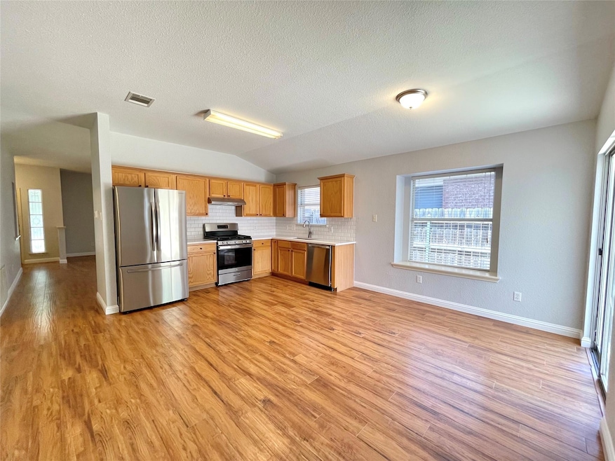 Kitchen with stainless steel appliances, light co