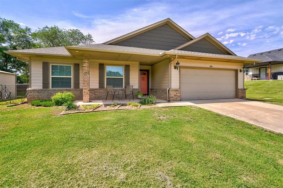 View of front of property with a garage and a fron